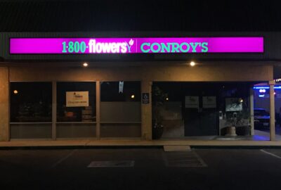 1-800-Flowers storefront lighted box sign at night