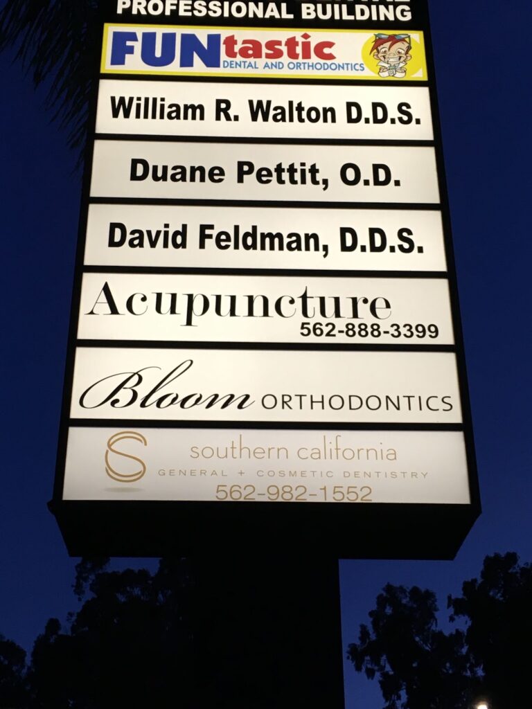 A custom light box pylon sign advertising multiple dental practices