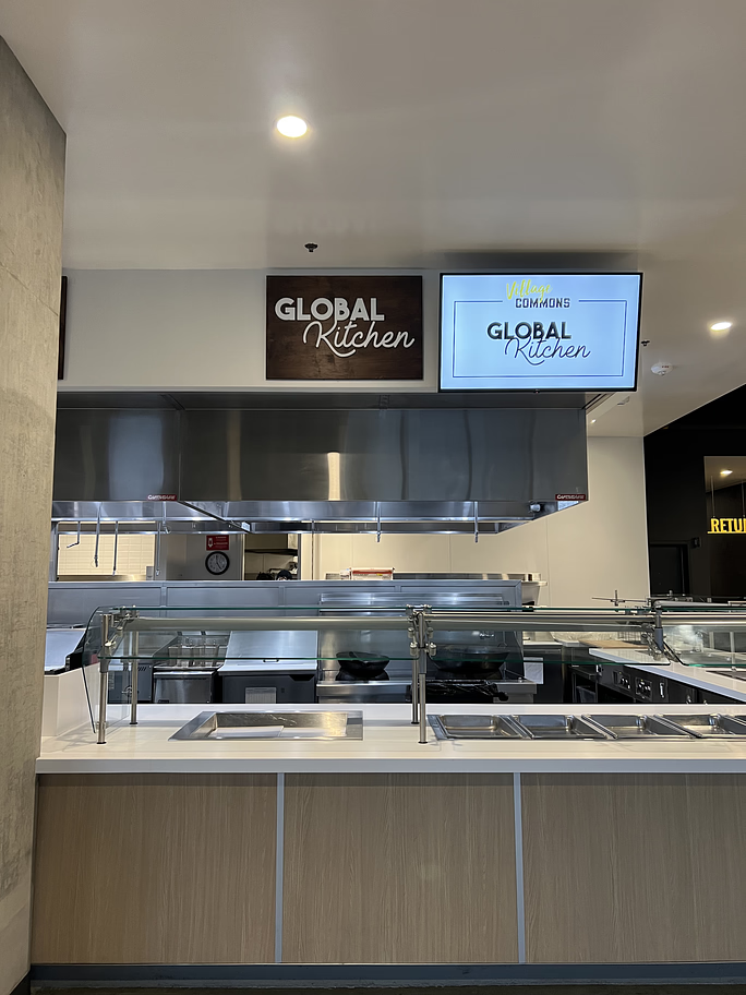 a mounted sign in a kitchen area reading global kitchen