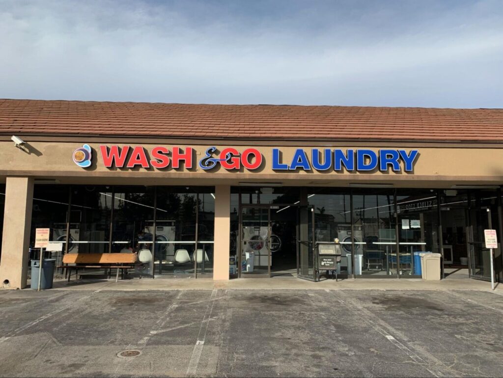A channel letter sign advertising Wash & Go Laundry