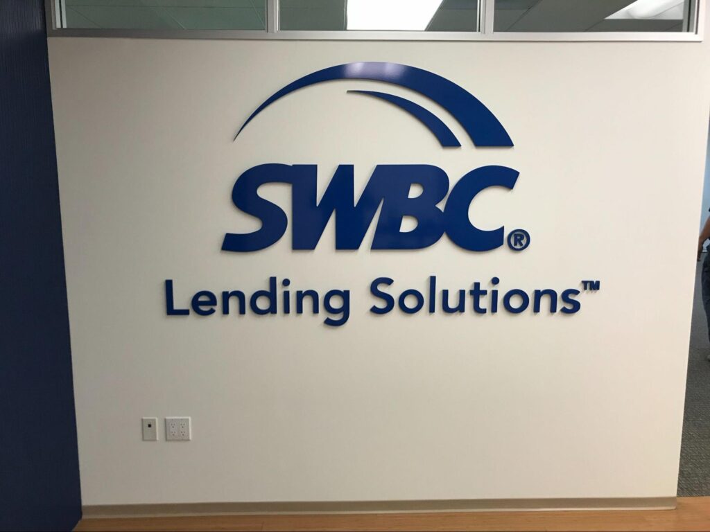 Indoor business sign for SWBC Lending Solutions.