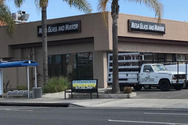 A sign box on a business called Mega Glass and Mirror