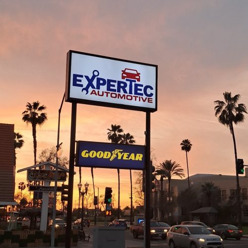 a twin-pole pylon sign advertising Good Year and Expertec Automotive